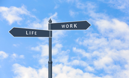 Image of Signpost against beautiful blue sky, space for text. Concept of balance between work and life