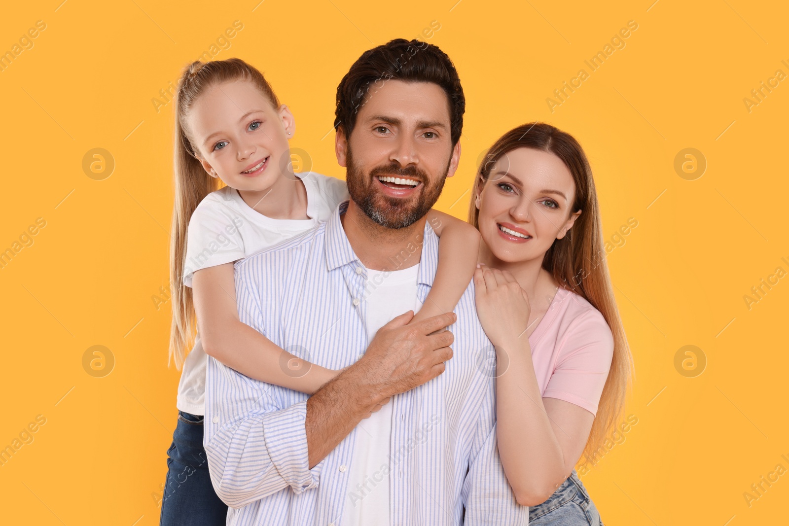 Photo of Portrait of happy family on orange background