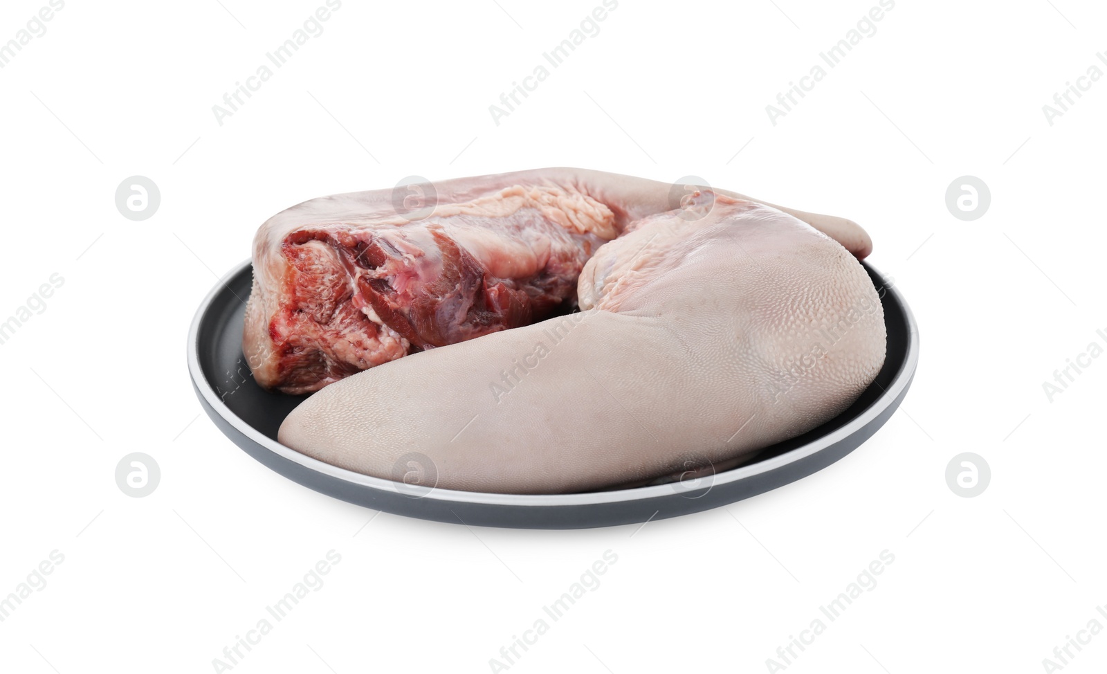 Photo of Plate with raw beef tongues on white background