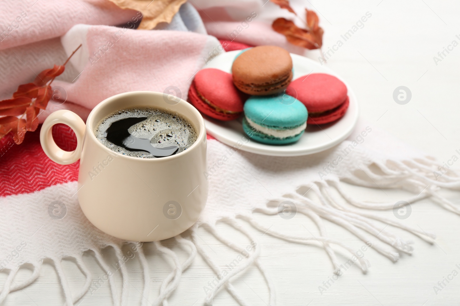 Photo of Composition with hot drink and warm plaid on white wooden table