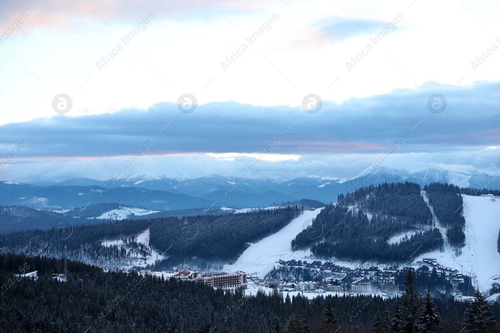 Photo of Beautiful mountain landscape with forest and ski resort in winter