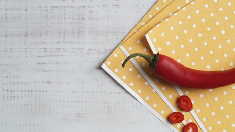 Photo of Pepper plasters and chili on white wooden table, top view. Space for text