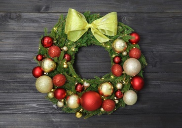 Beautiful Christmas wreath with festive decor on black wooden background