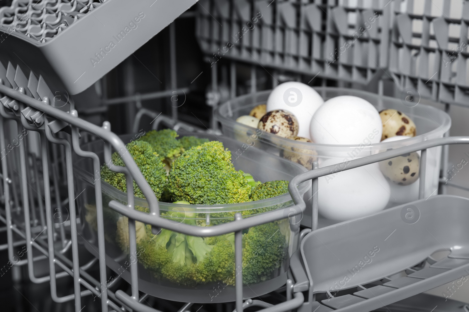 Photo of Cooking raw broccoli and eggs in modern dishwasher, closeup