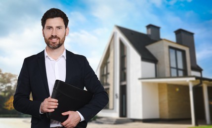 Image of Real estate agent with portfolio near beautiful house outdoors. Space for text