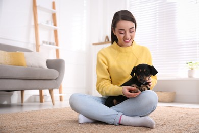 Photo of Woman with cute puppy indoors. Lovely pet