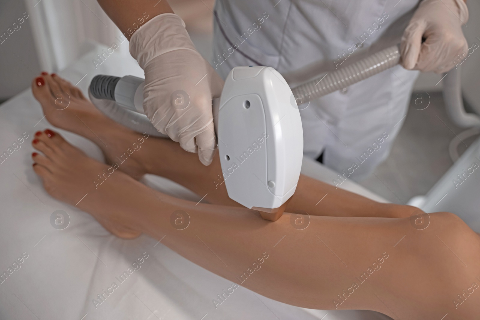 Photo of Woman undergoing laser epilation procedure in beauty salon, closeup