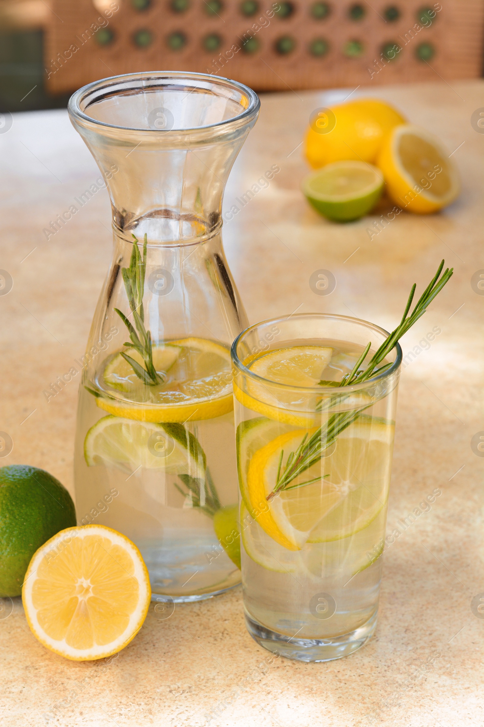 Photo of Summer refreshing lemonade on light table in cafe