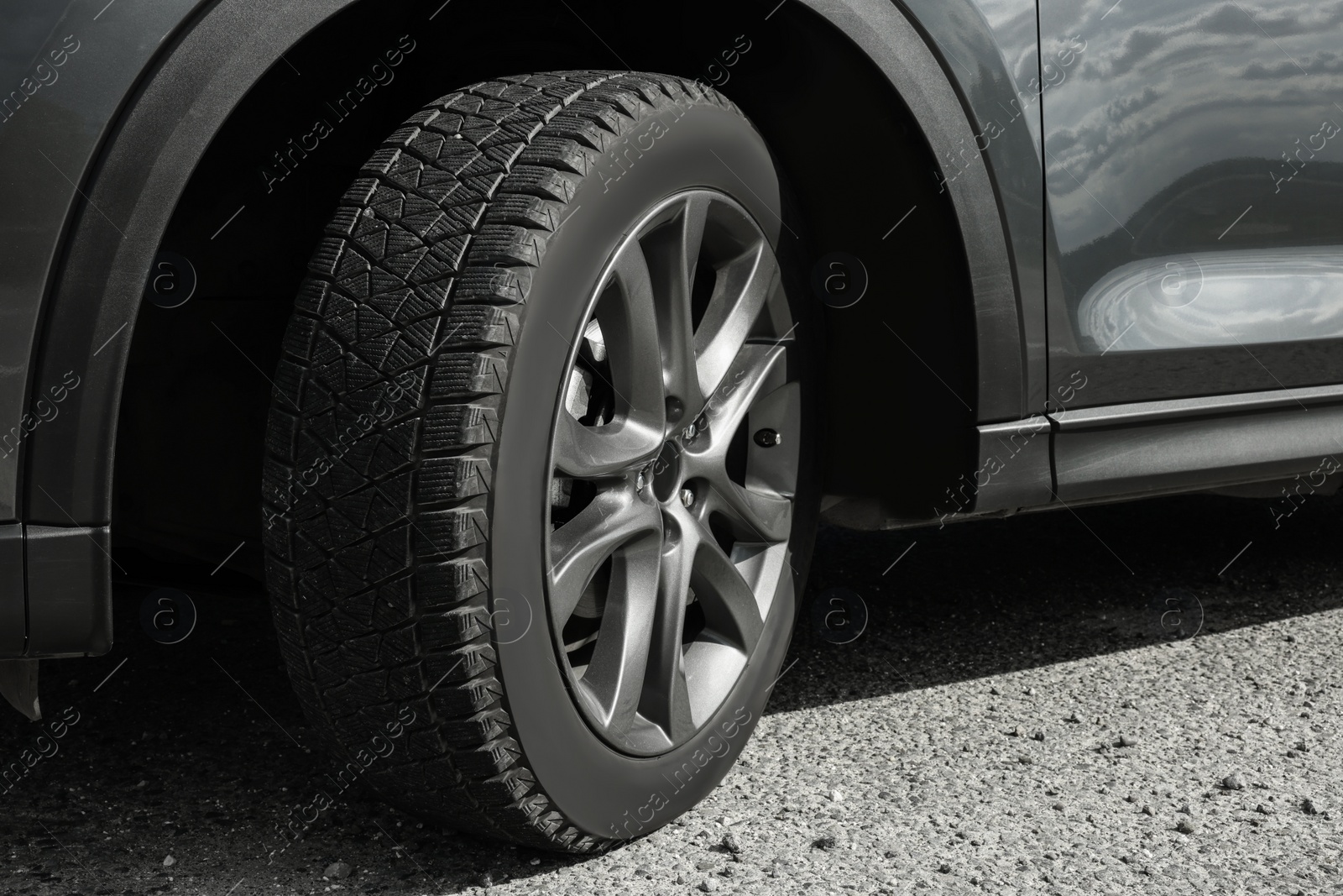 Photo of New black modern car on asphalt road, closeup