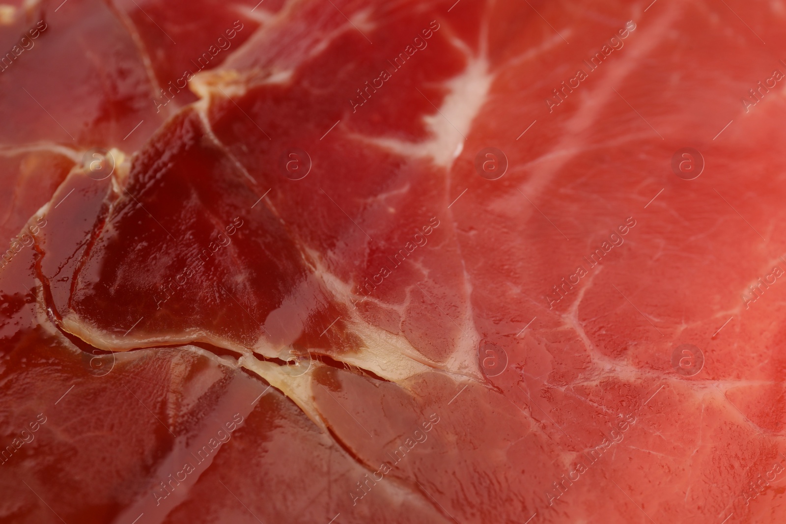 Photo of Delicious sliced jamon as background, closeup view