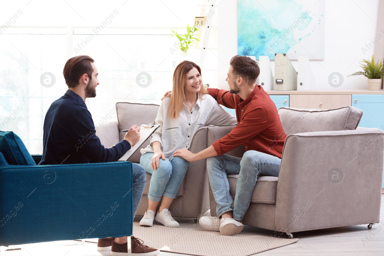 Photo of Family psychologist working with young couple in office