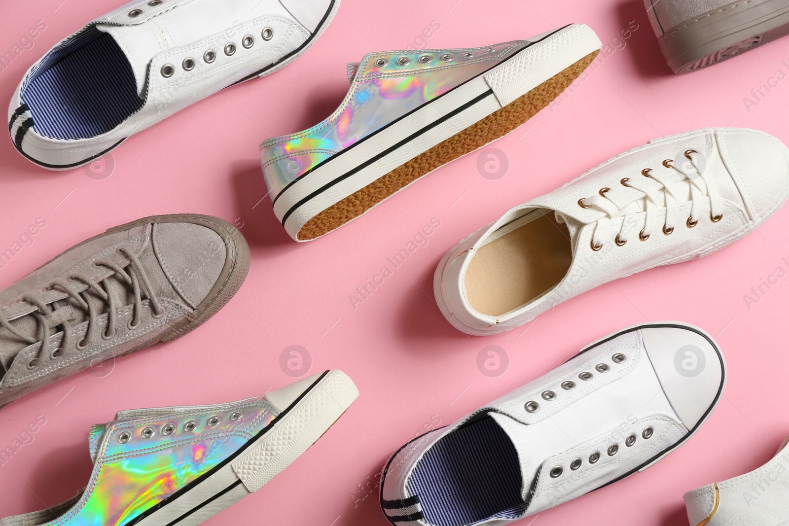 Photo of Flat lay composition with stylish sneakers on color background