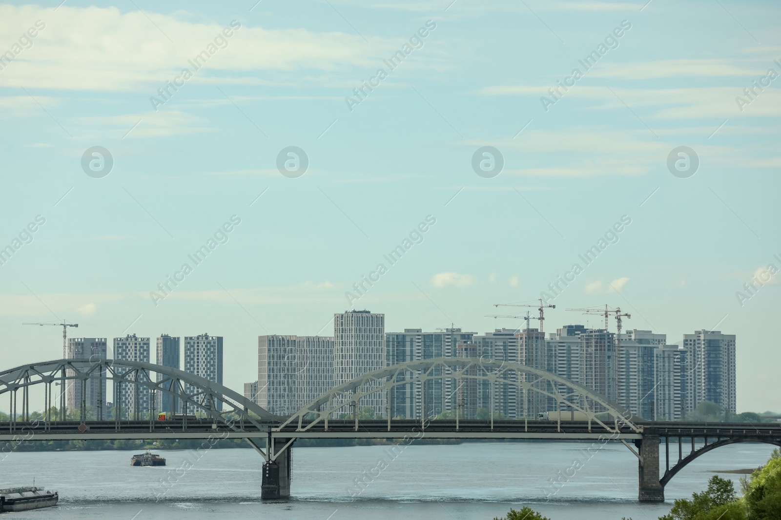 Photo of Beautiful view of cityscape with modern buildings and bridge over river