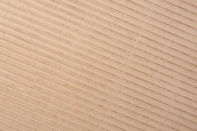 Photo of Texture of beige corrugated paper sheet as background, closeup