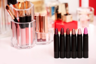 Photo of Different lipsticks on dressing table. Space for text