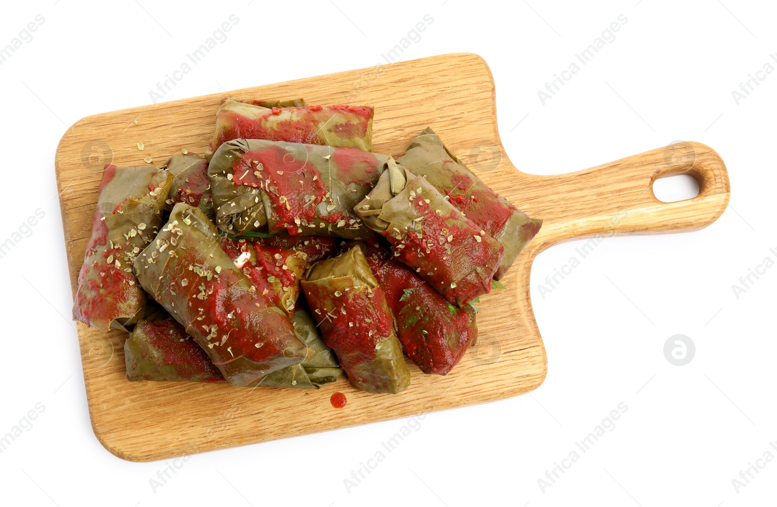 Photo of Delicious stuffed grape leaves with tomato sauce on white background, top view