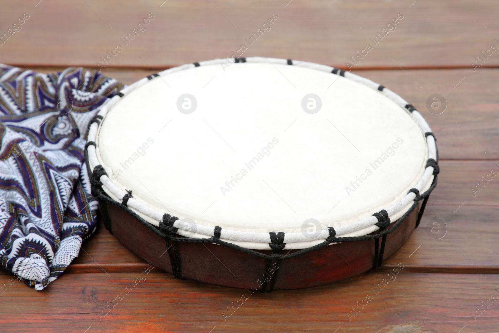 Photo of Modern drum on wooden table. Musical instrument