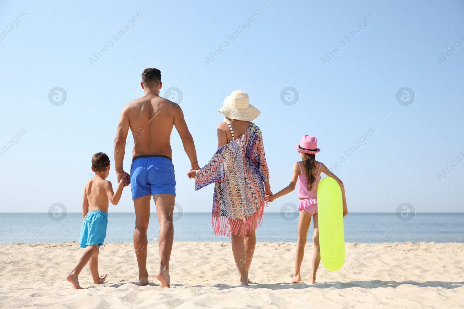 Photo of Family at beach on sunny summer day