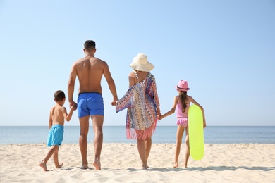 Photo of Family at beach on sunny summer day