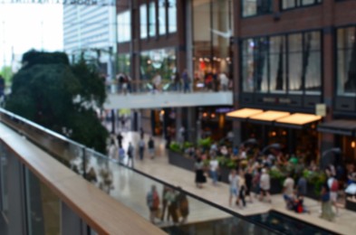 Photo of Blurred view of big shopping mall with many stores