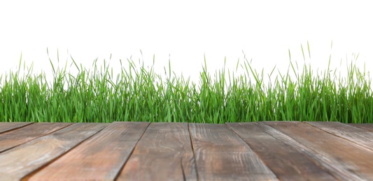 Photo of Wooden deck and green grass isolated on white