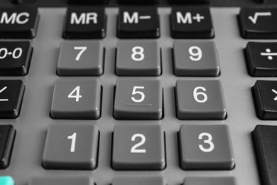 Closeup view of modern calculator as background