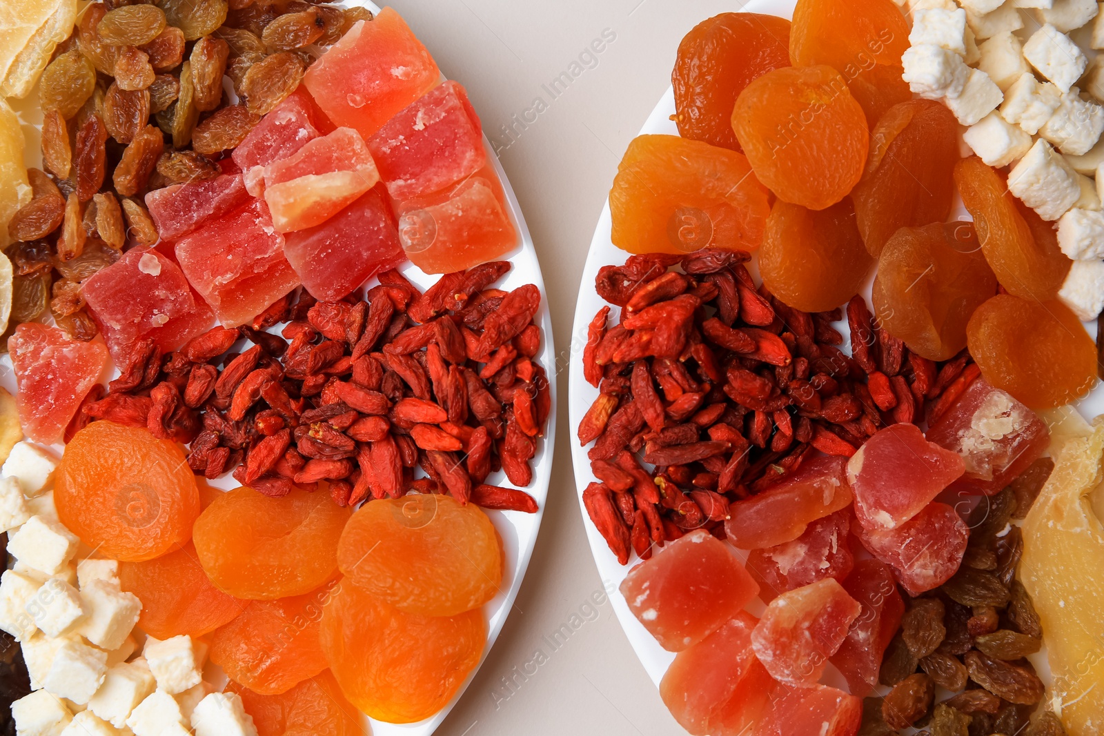 Photo of Plates with different dried fruits on white background, top view