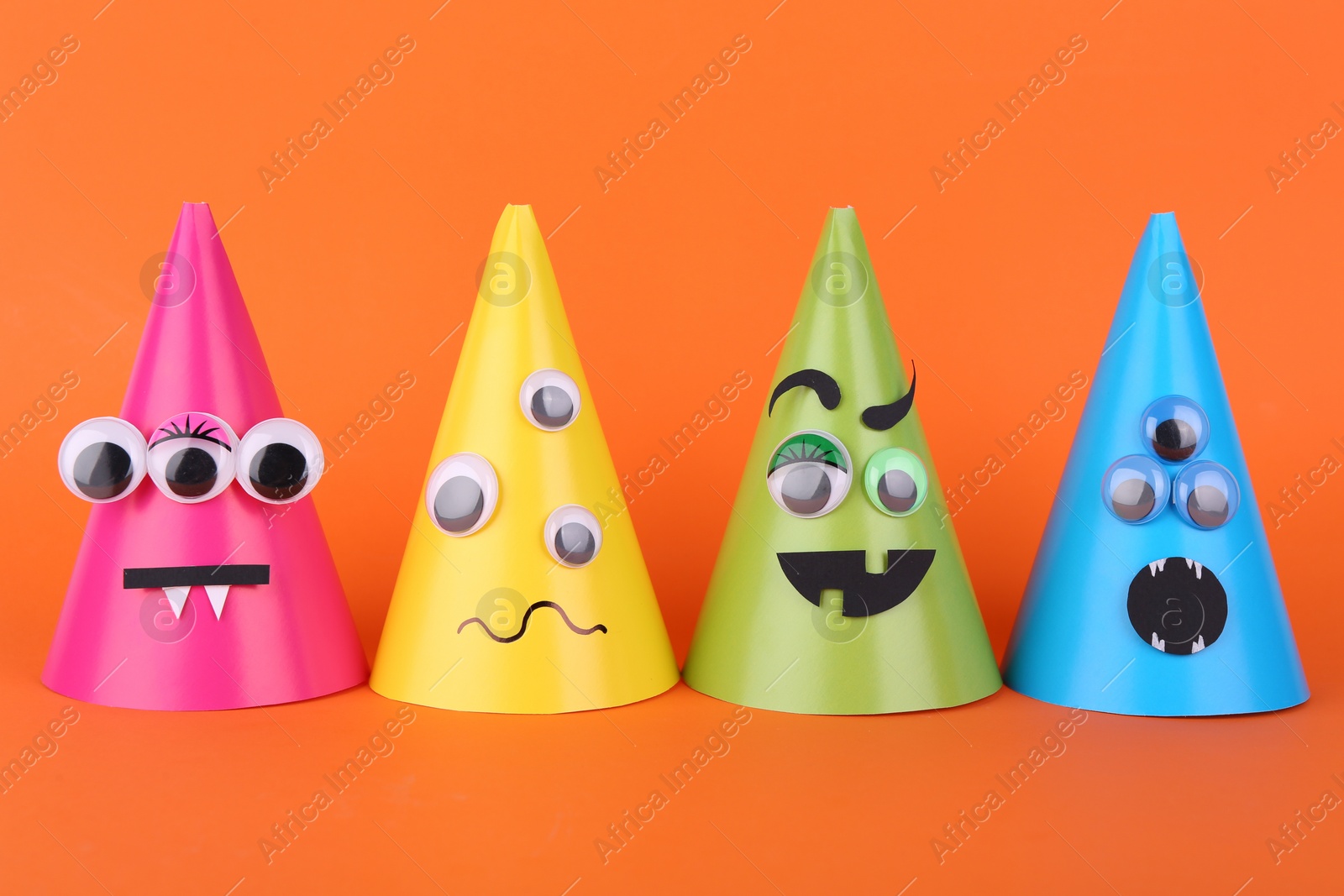 Photo of Spooky paper Halloween monsters on orange background