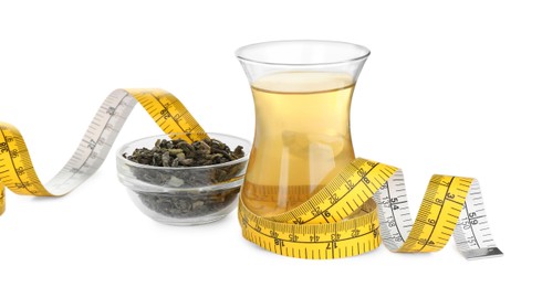 Diet herbal tea, dry leaves and measuring tape on white background