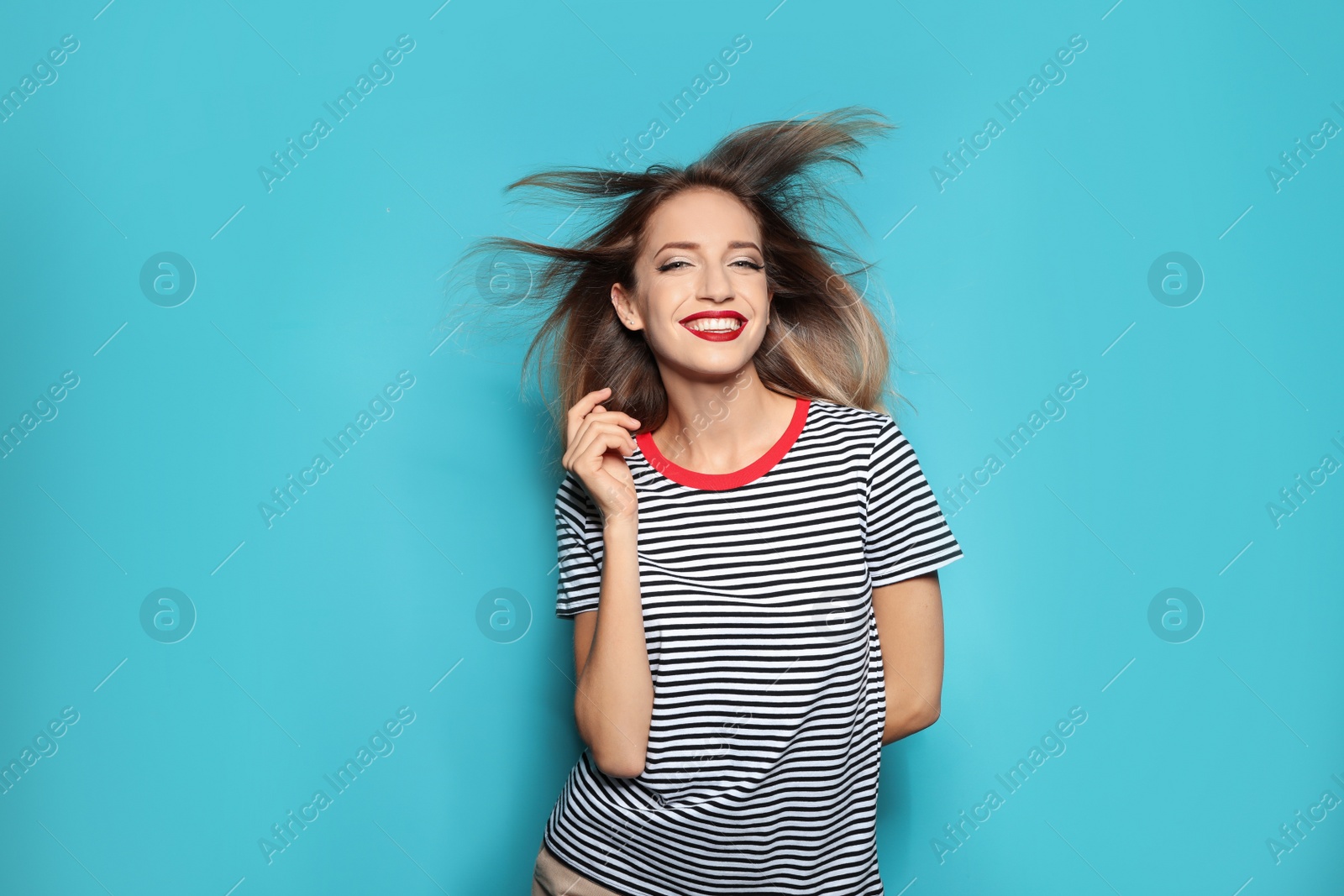 Photo of Beautiful young woman with healthy long blonde hair on color background