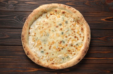 Photo of Delicious cheese pizza on wooden table, top view