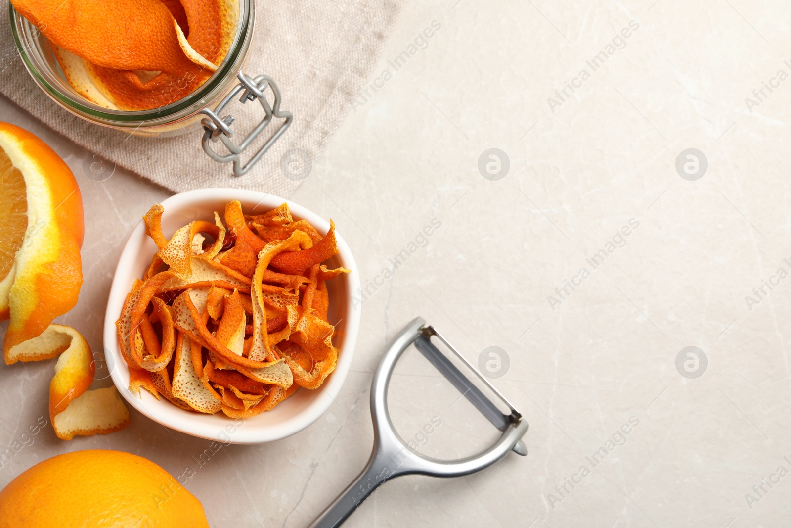 Photo of Dry orange peels and fresh fruits on white table, flat lay. Space for text