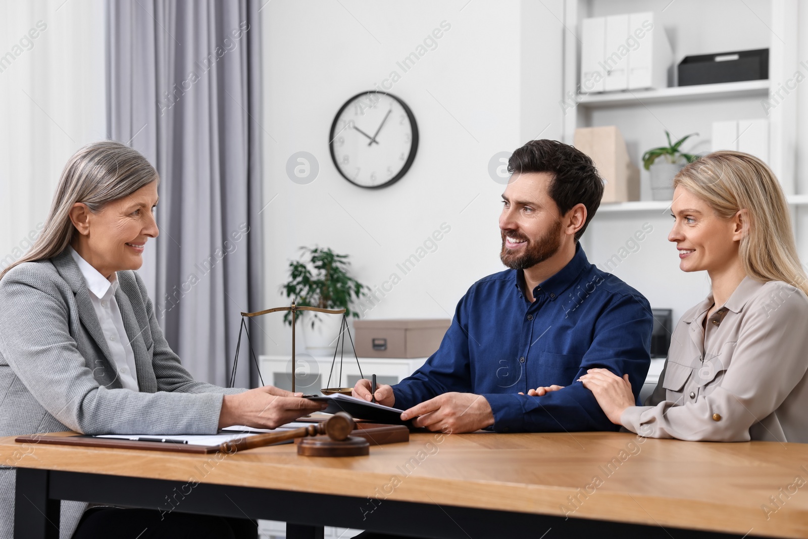 Photo of Couple having meeting with lawyer in office