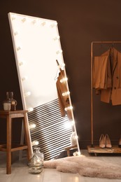 Stylish mirror with light bulbs in dressing room. Interior design