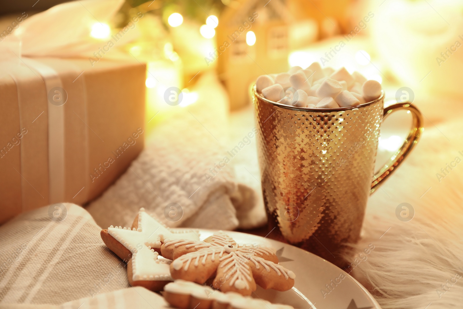 Photo of Cup of hot drink with marshmallows and Christmas cookies at table