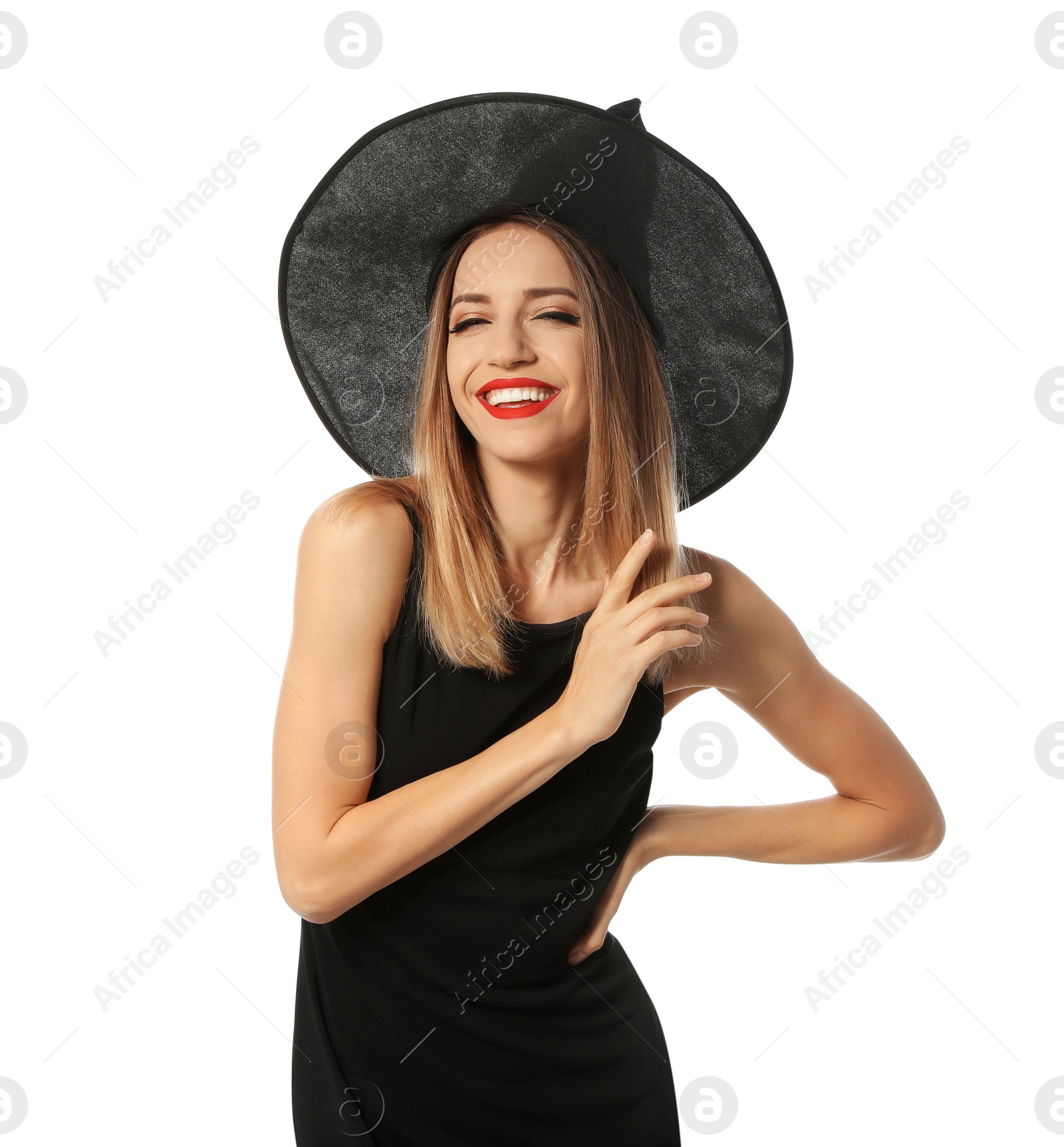 Photo of Beautiful young woman wearing witch costume for Halloween party on white background