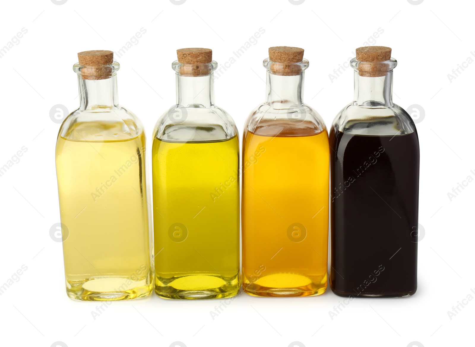 Photo of Vegetable fats. Bottles of different cooking oils isolated on white