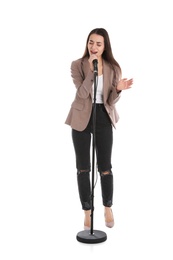 Young stylish woman singing in microphone on white background