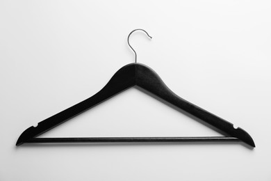 One black hanger on white background, top view