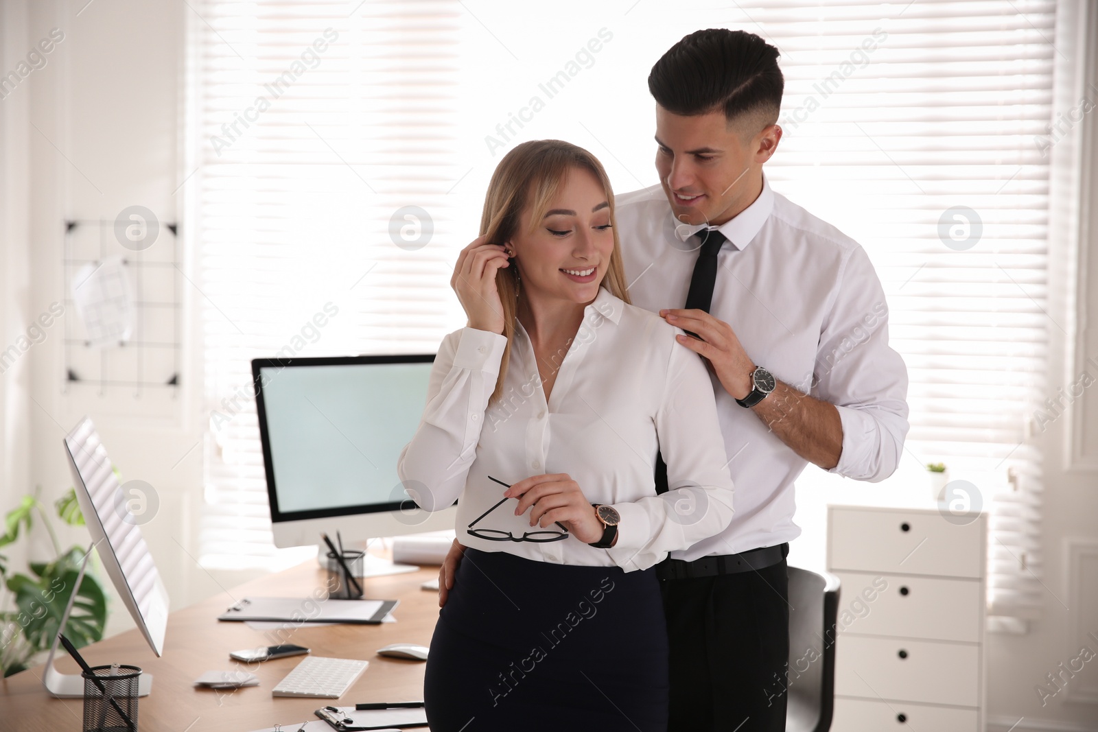 Photo of Colleagues flirting with each other during work in office