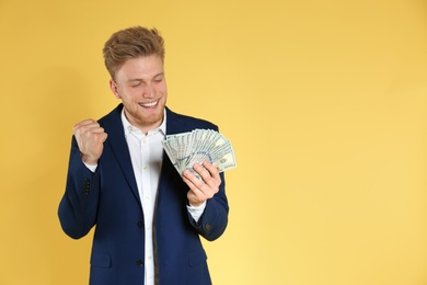 Photo of Businessman with money on color background. Space for text