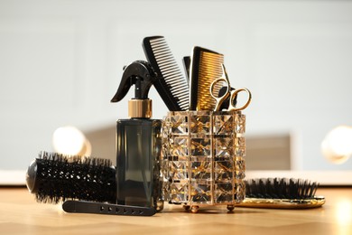 Photo of Set of hairdresser tools on table in salon