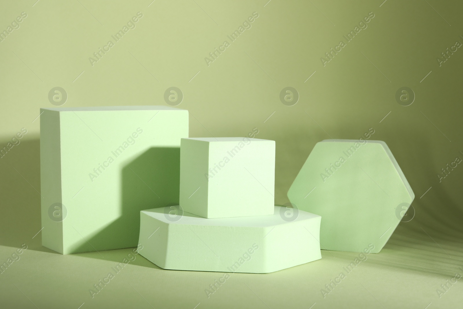 Photo of Presentation of product. Podiums on light green background. Space for text
