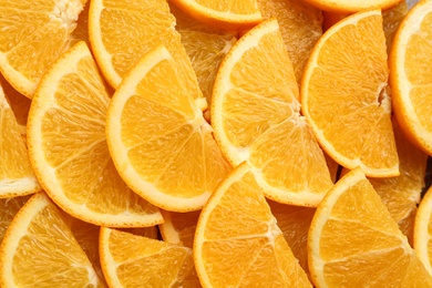 Slices of delicious oranges as background, closeup