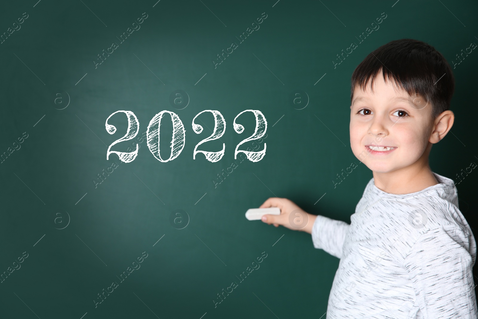 Image of Back to school 2022. Cute child near chalkboard