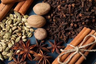 Different spices and nuts on table, top view