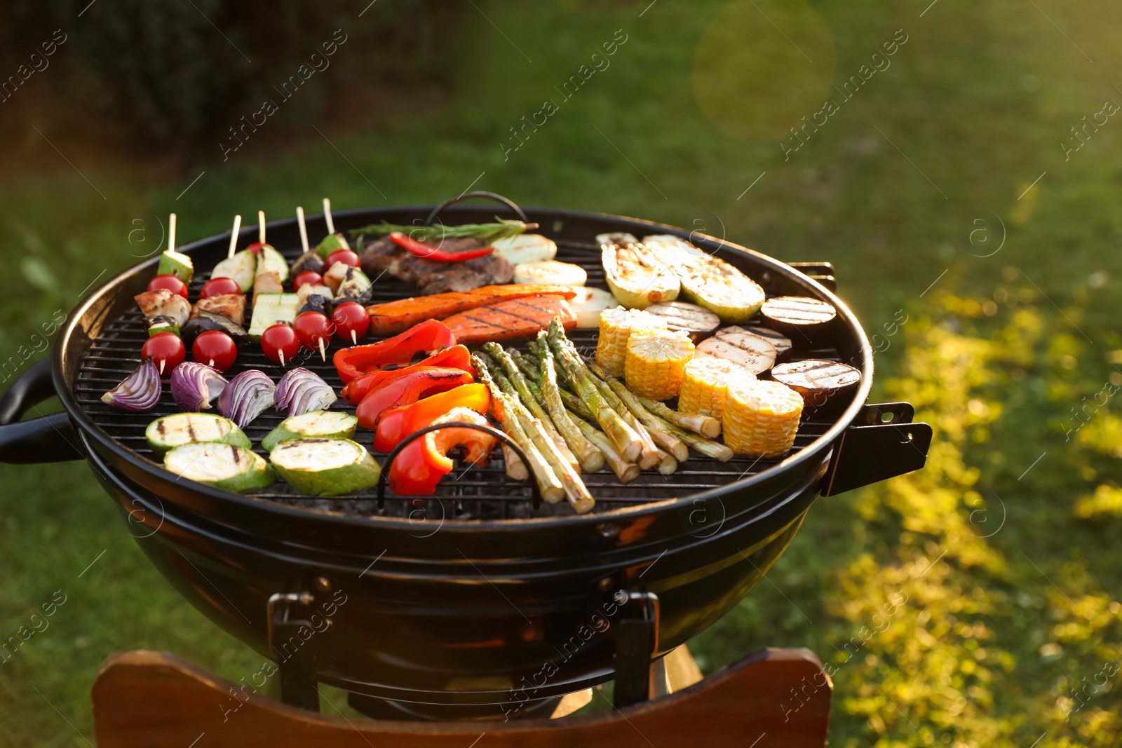 Photo of Delicious grilled vegetables on barbecue grill outdoors