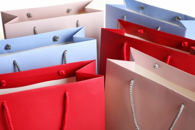 Photo of Colorful paper shopping bags as background, closeup