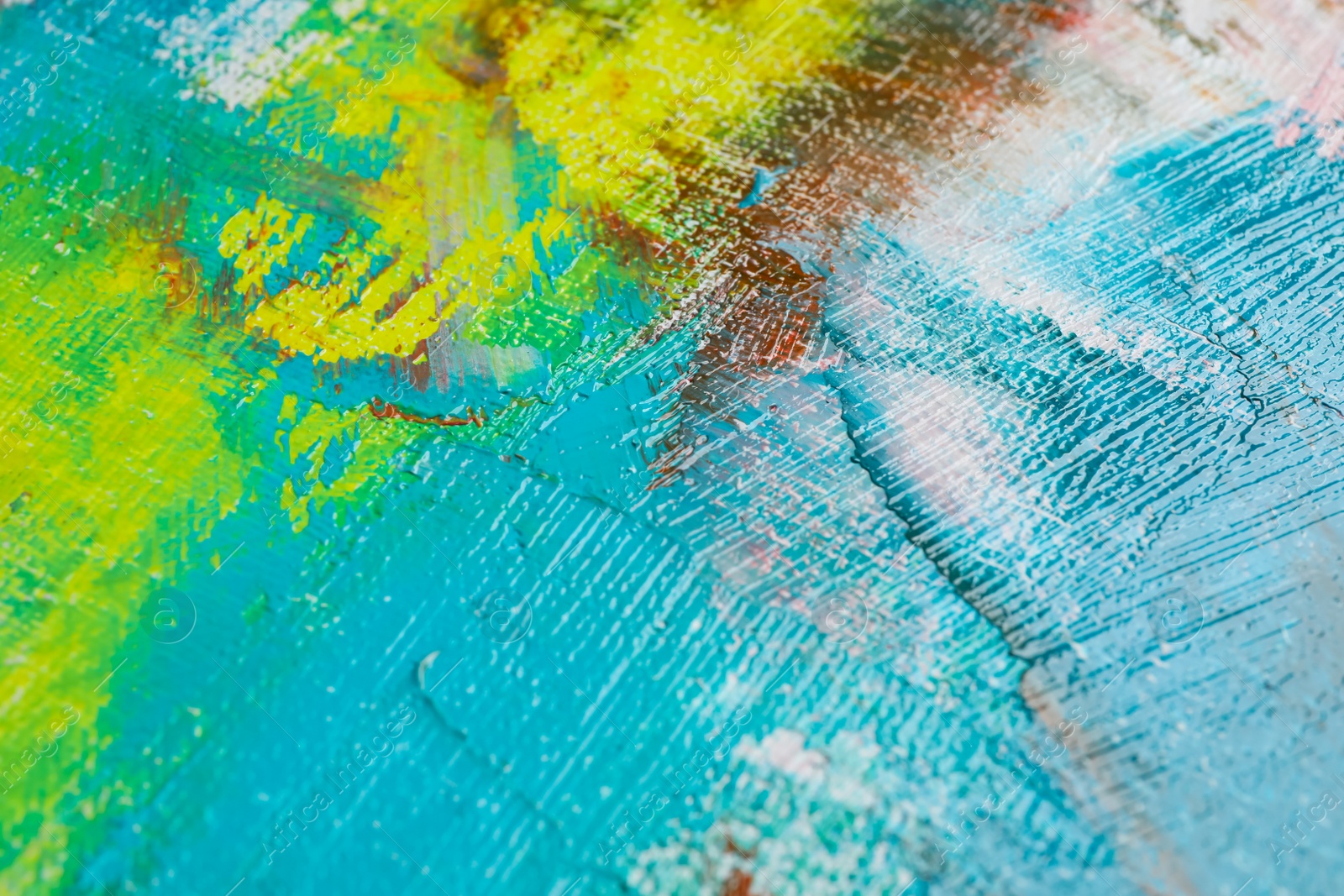 Photo of Strokes of colorful acrylic paints on canvas, closeup