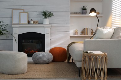 Stylish comfortable poufs near sofa in room. Home design